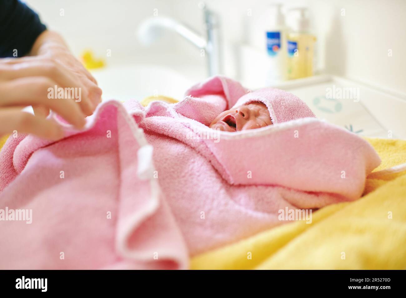 Newborn baby covered in towel after taking bath Stock Photo Alamy