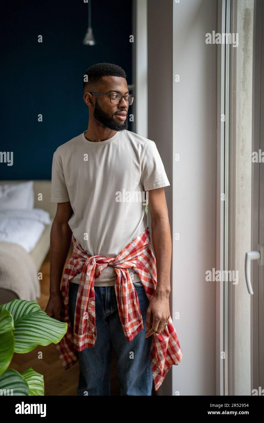 Domestic portrait of bearded African American guy in casual clothes ...