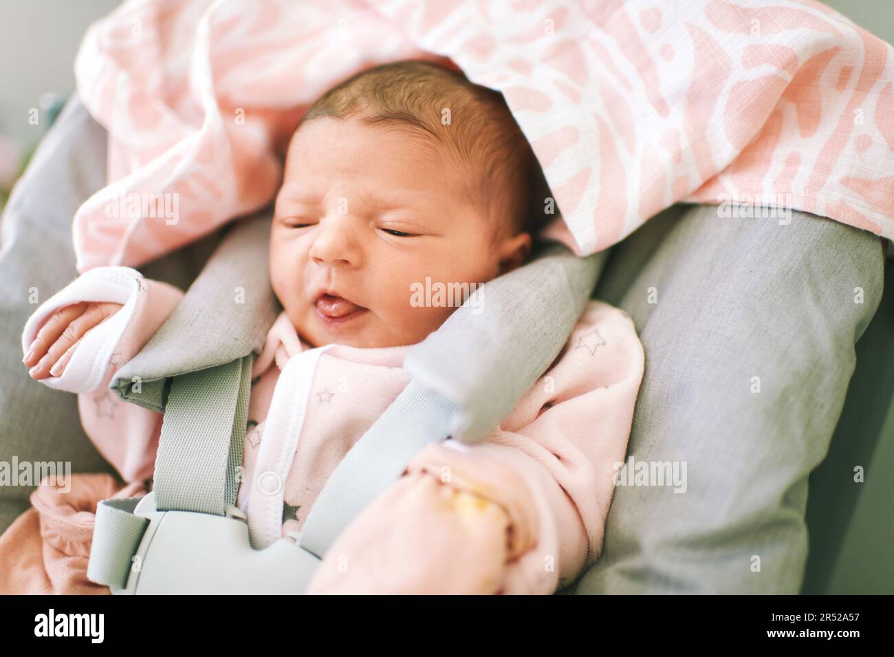 Funny newborn baby sitting in high chair Stock Photo Alamy