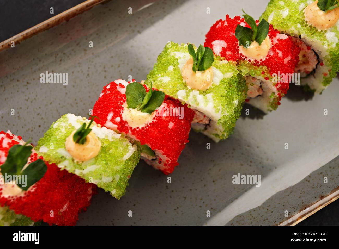 Delectable sushi roll topped with delicate flying fish roe Stock Photo
