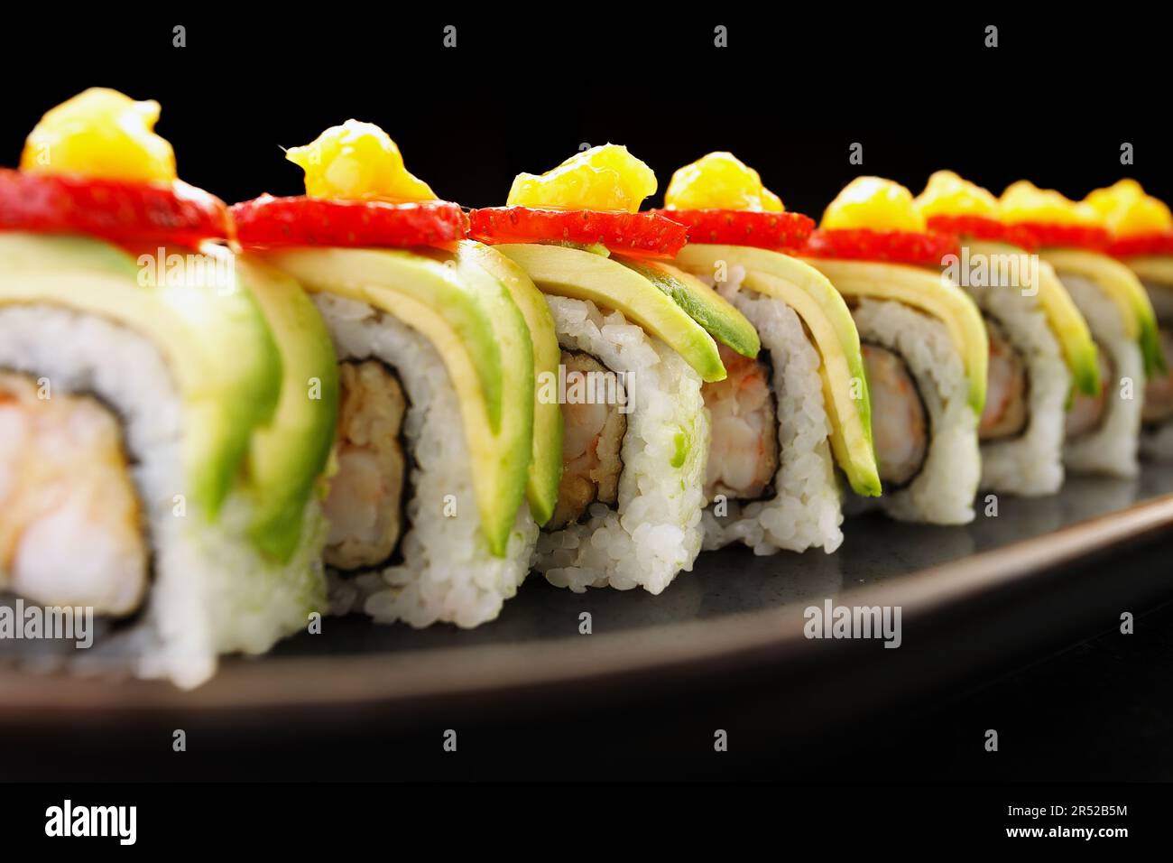 sushi delight with creamy avocado, succulent shrimp, and juicy strawberry Stock Photo