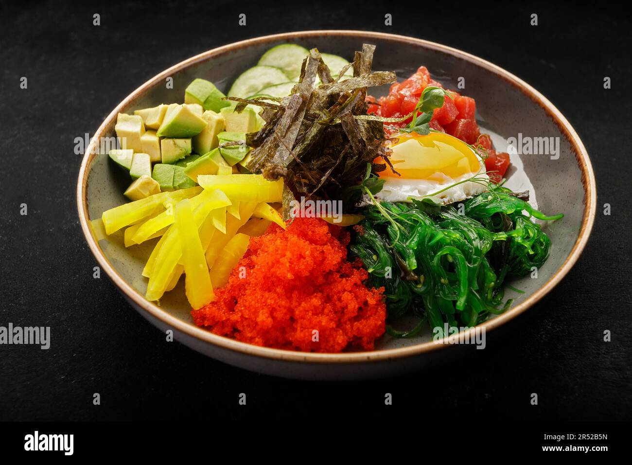 seaweedinfused pibimpap with flying fish roe, meat, fish, and nori