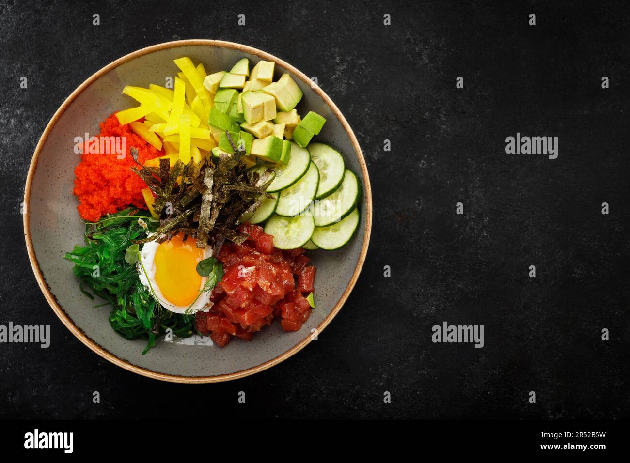 seaweedinfused pibimpap with flying fish roe, meat, fish, and nori