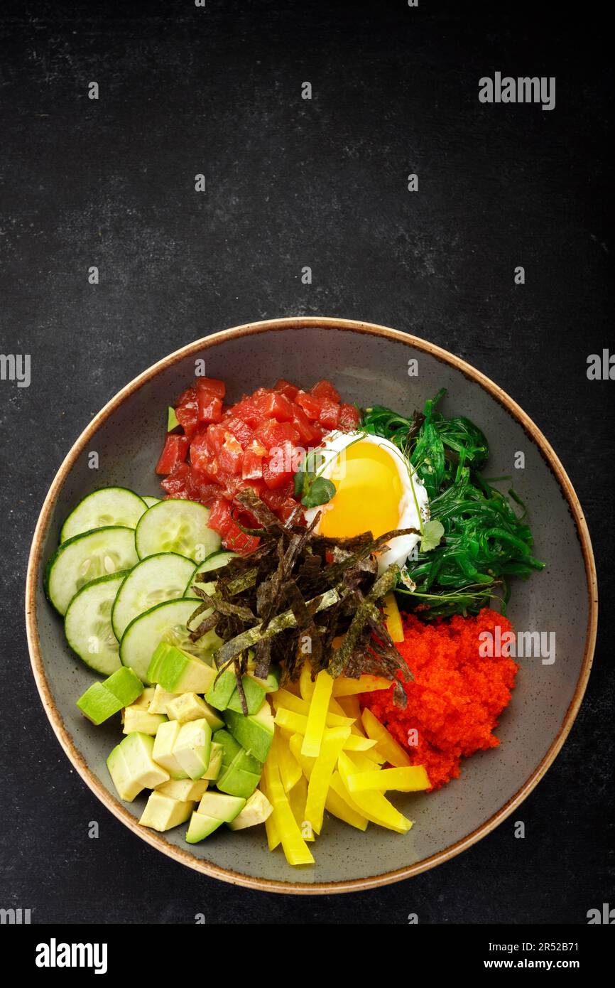 seaweedinfused pibimpap with flying fish roe, meat, fish, and nori