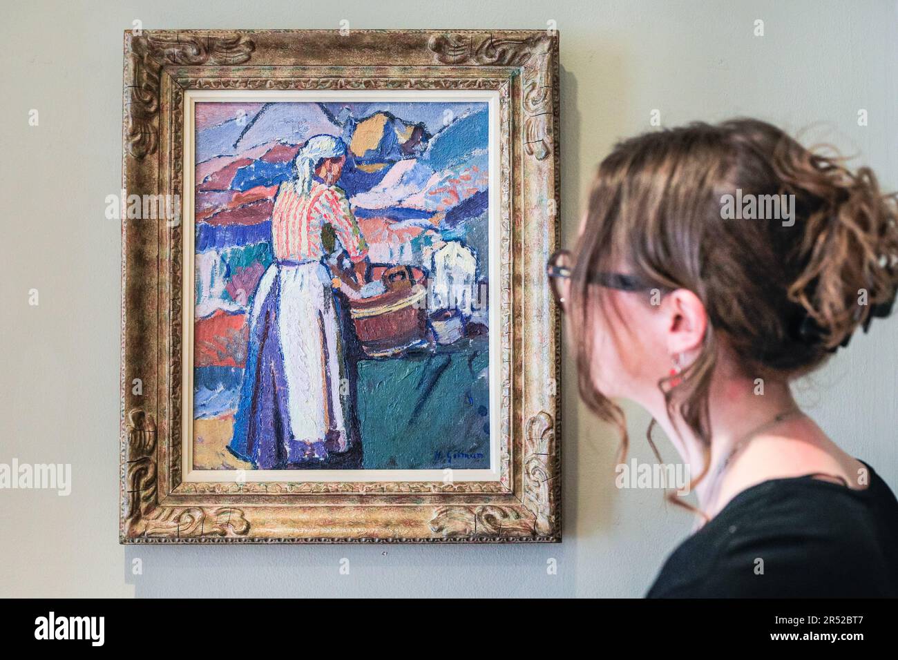 London, UK. 31st May, 2023. Gallery staff with Harold Gilman, The Washerwoman (La Lavandeuse), c