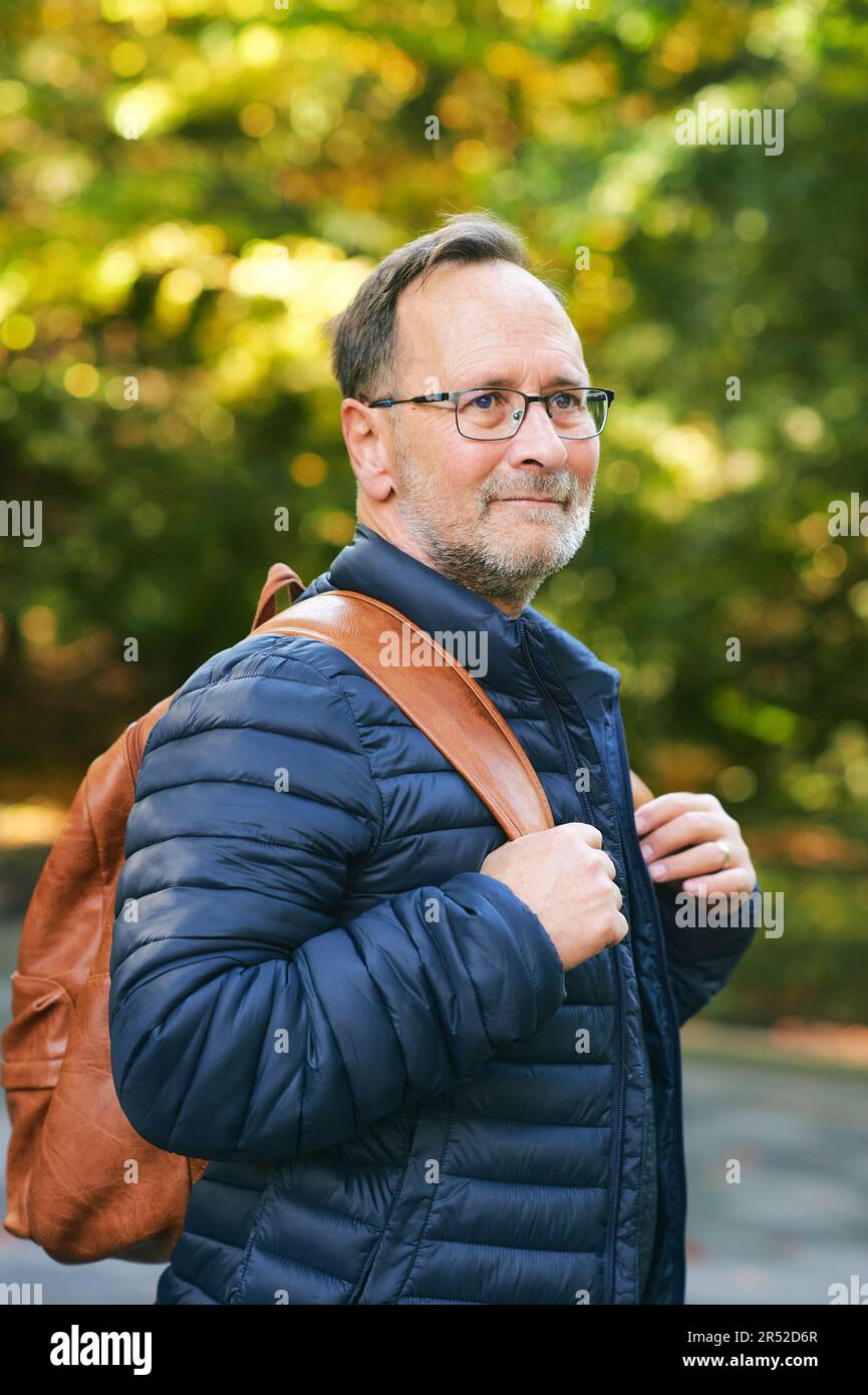 Outdoor portrait of middle age man wearing backpack Stock Photo