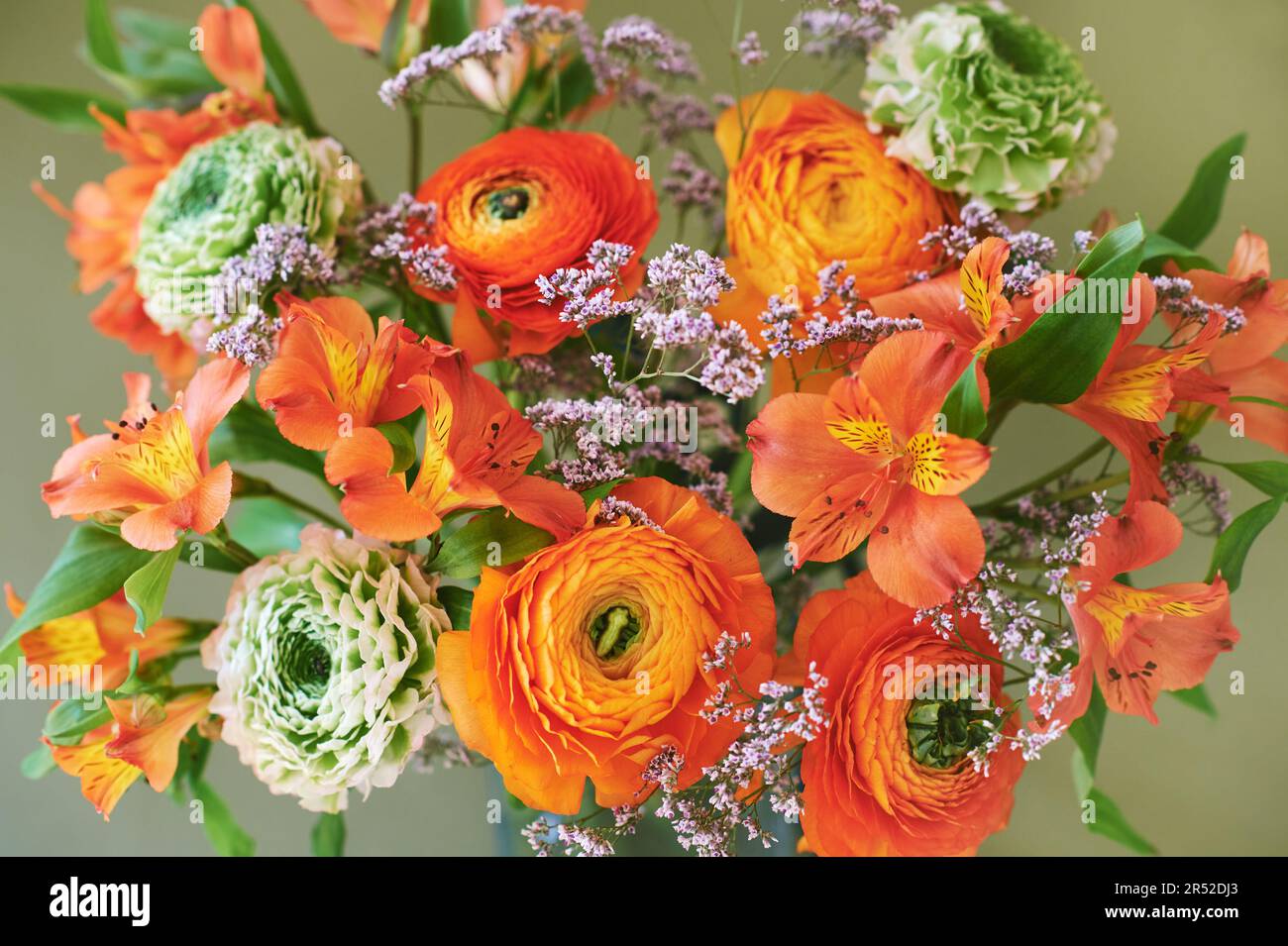 Flat lay image of green and orange ranunculus and alstroemeria bouquet Stock Photo