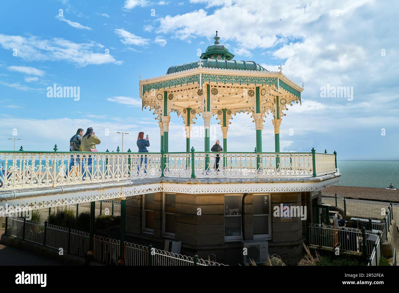 Visitors on the bandstand (known as the birdcage) at the promenade at Brighton and Hove, south coast of England. Stock Photo