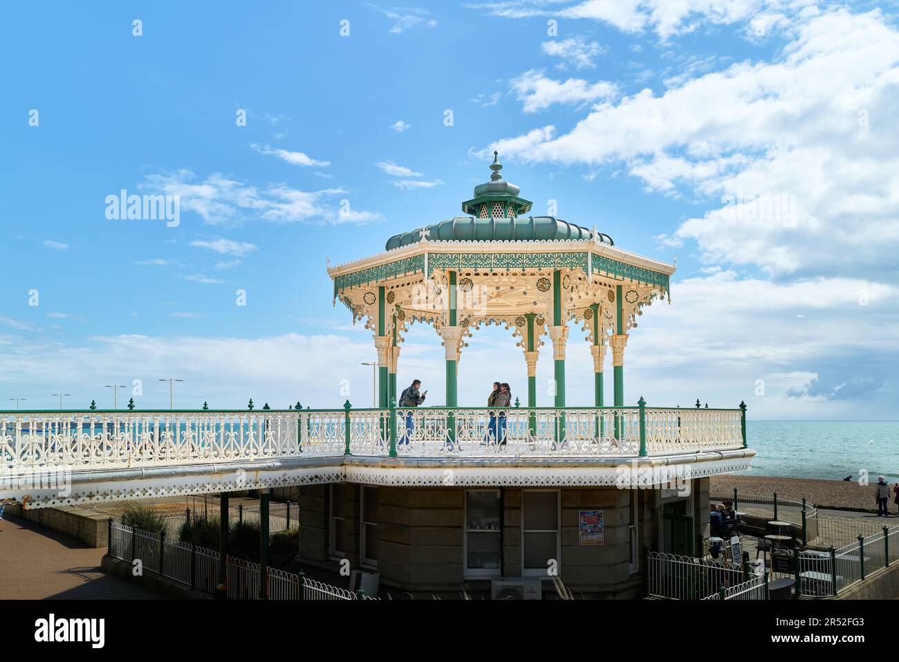 Visitors on the bandstand (known as the birdcage) at the promenade at Brighton and Hove, south coast of England. Stock Photo