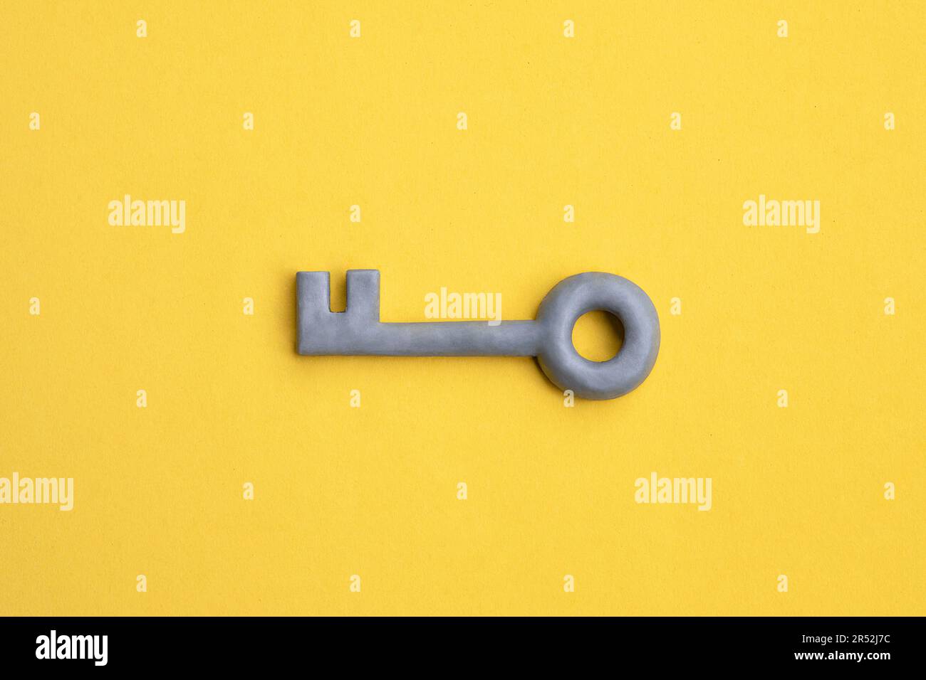 Plasticine key on yellow background. Safety, protection concept, internet password, security concept. Access or privacy symbol. Stock Photo