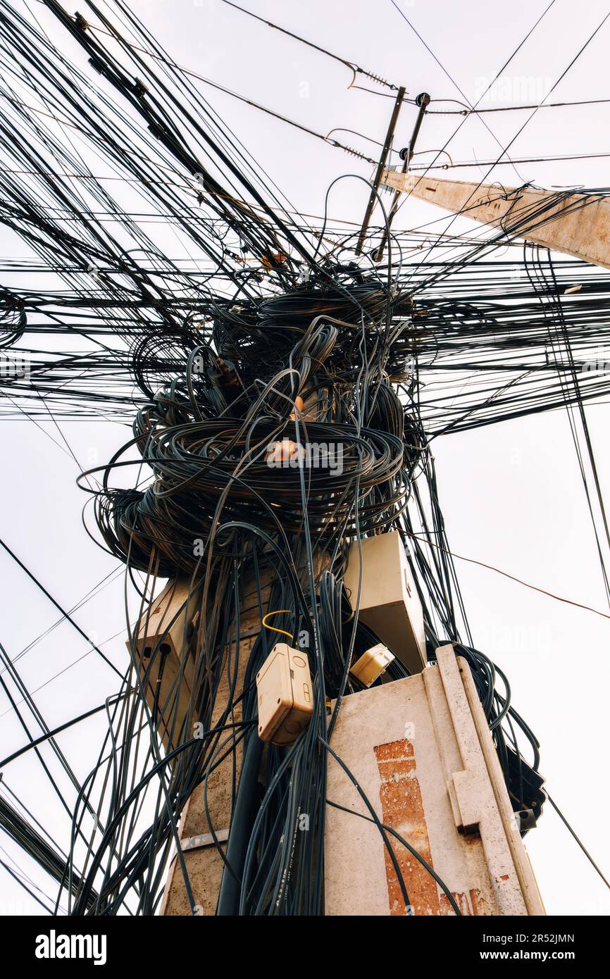 Large coils of wires and cables on a pole, the chaos of Asian power