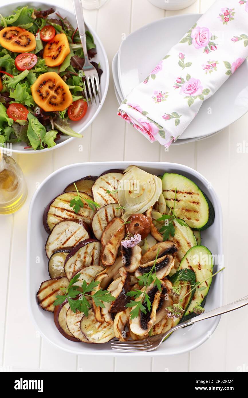 Grilled vegetables and mushrooms and salad with tamarillos Stock Photo
