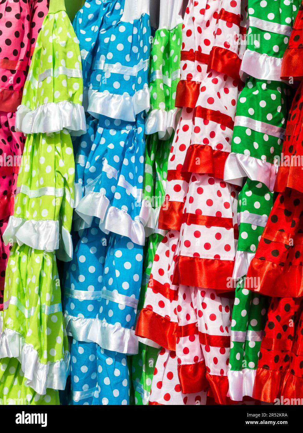 Brightly Coloured Girls Spanish Dresses Stock Photo