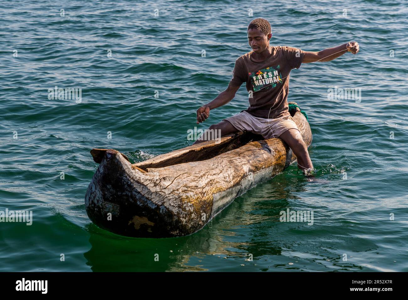 Traditional fishing of freshwater fish on Lake Malawi with fishing line in dugout canoe Stock Photo