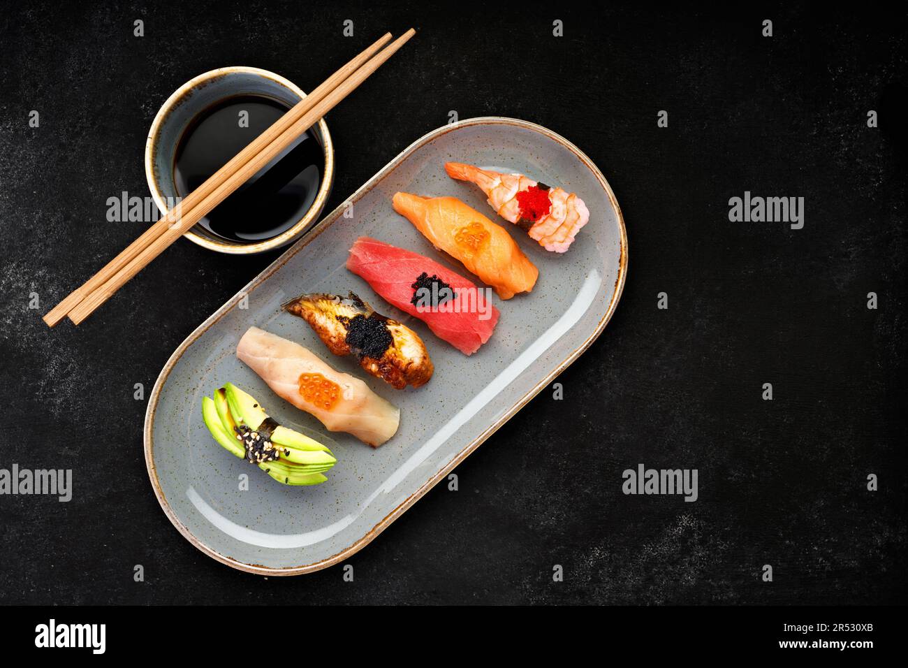 exquisite nigiri sushi featuring a variety of flavors including shrimp, eel, avocado, salmon, and tuna Stock Photo