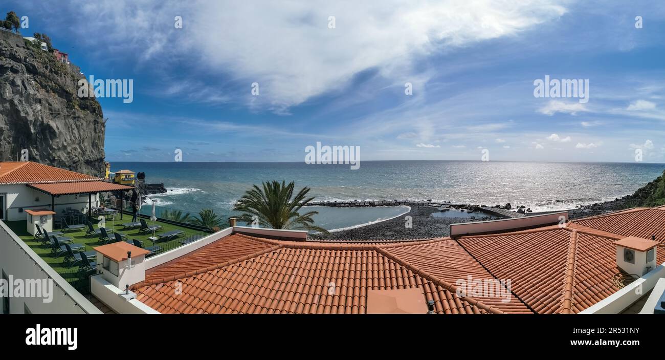 Madeira Island Portugal - 04 21 2023: Panoramic view of Ponta do Sol beach, a small touristic village in the city of Funchal, roof buildings and small Stock Photo