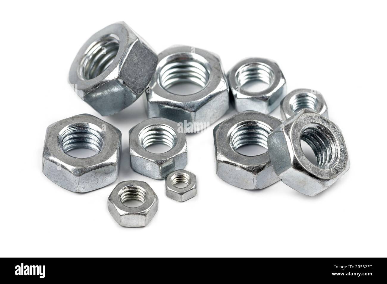 Close-up of steel screw nuts in different sizes on white background Stock Photo