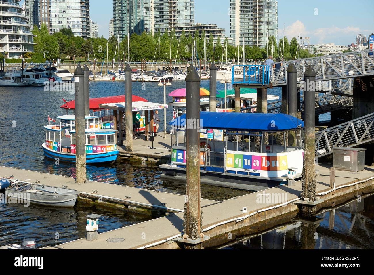 Colorful aquabus ferries docked on False Creek at Granville Island, Vancouver, British Columbia, Canada Stock Photo