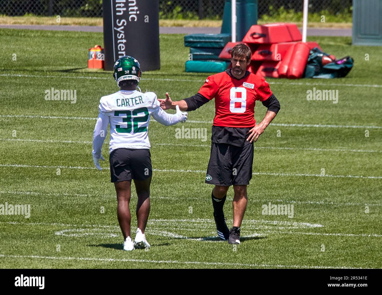 May 31, 2023, Florham Park, New Jersey, USA: Quarterback Aaron Rodgers (8)  and running back Michael Carter (32) shake during organized team activities  at the Atlantic Health Jets Training Center, Florham Park,