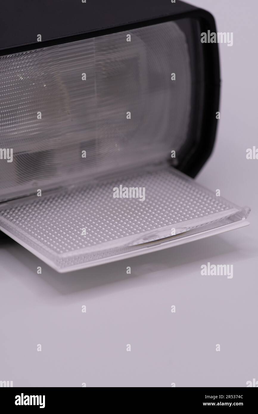 An external flash with diffuser engaged against a white background