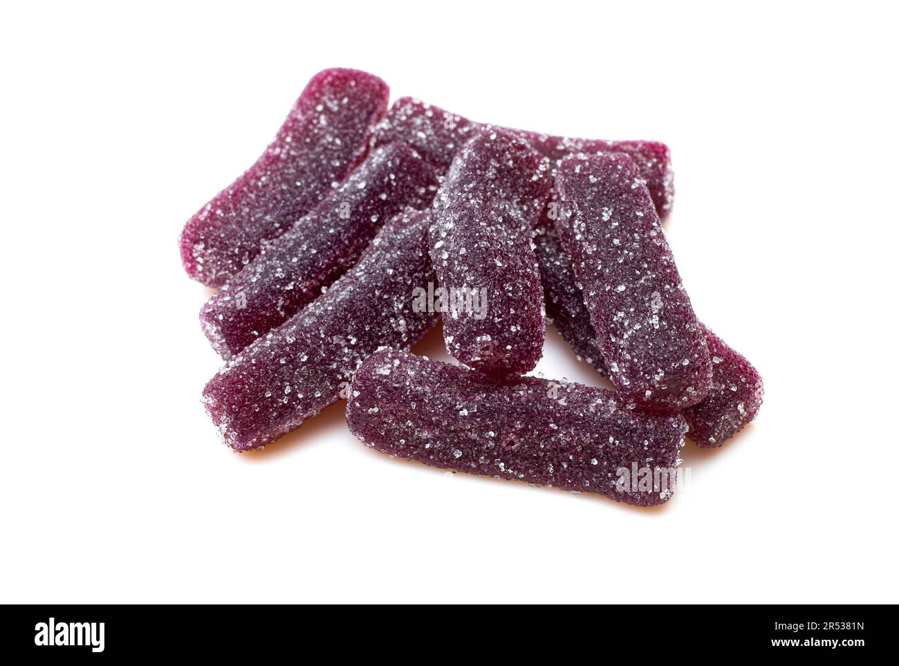 Pile of purple sugary jelly candies isolated on white background. Gummy worms treat Stock Photo