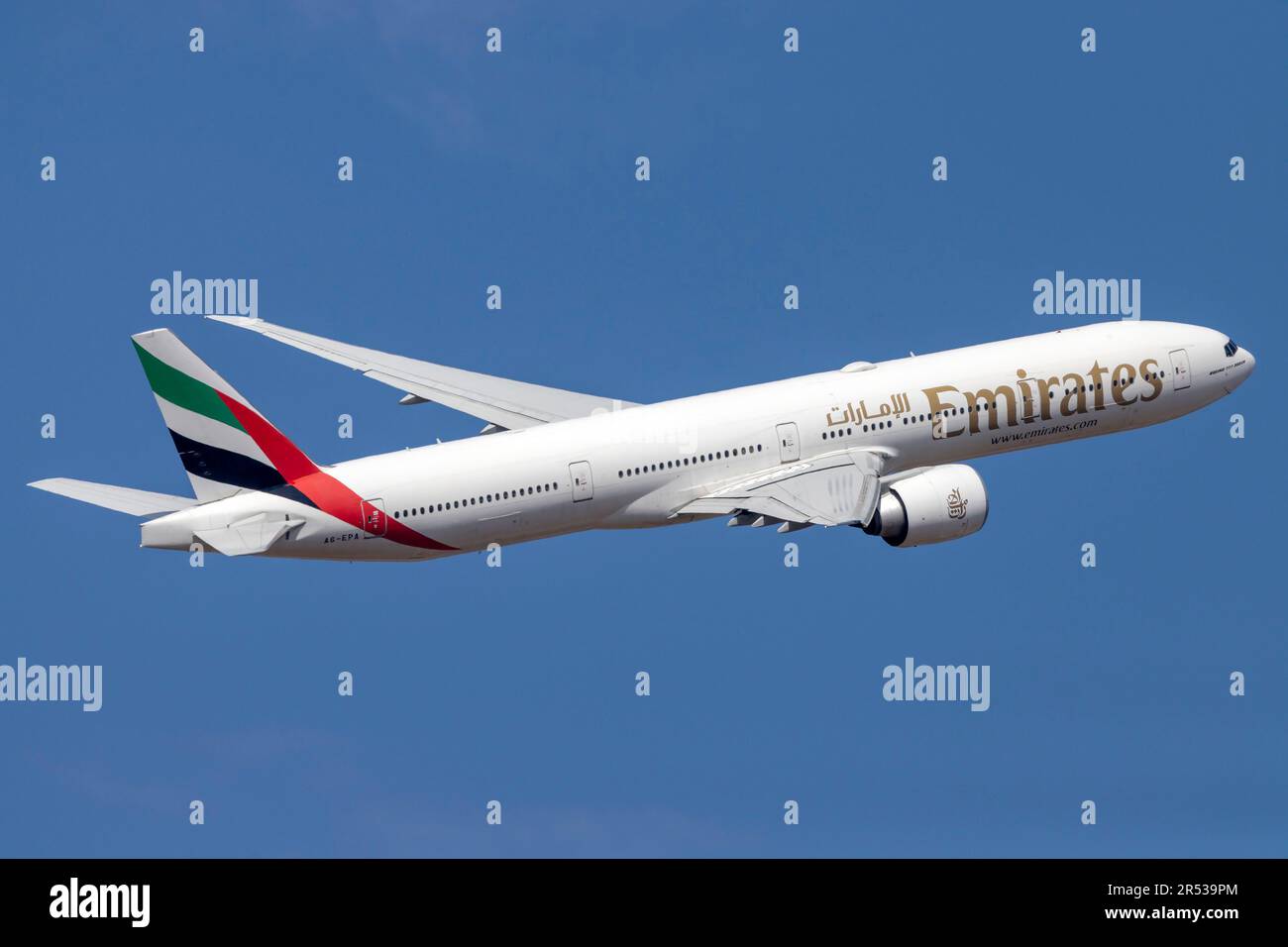 Emirates Boeing 777-31H-ER (REG: A6-EPA) climbing out of runway 13. Stock Photo