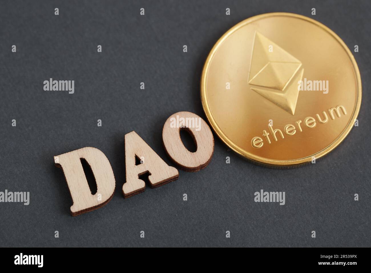 Decentralized Autonomous Organization. DAO, gold coin cryptocurrency  Ethereum on dark grey background Stock Photo - Alamy