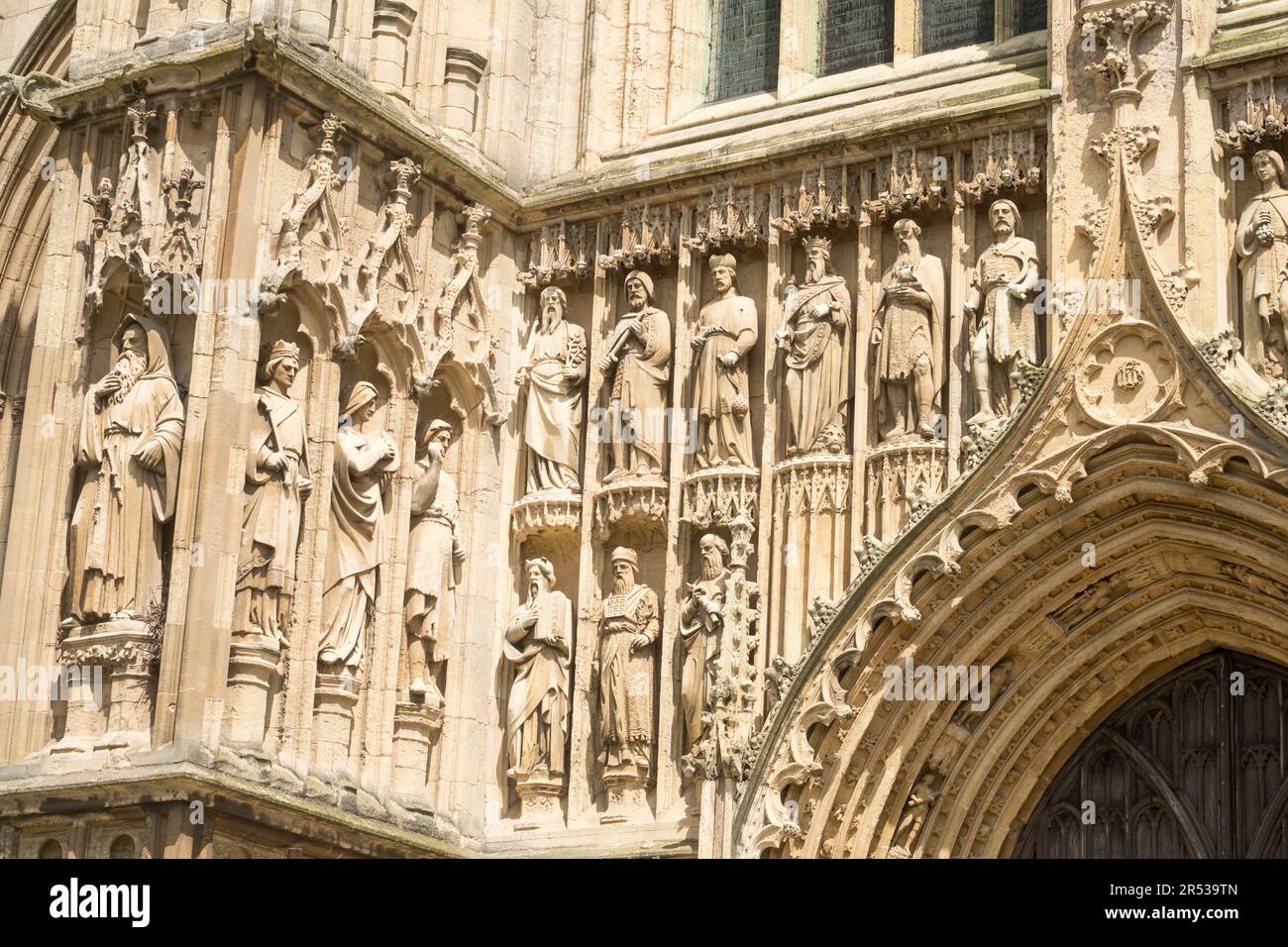 Statues carved above the entrance to the west façade of Beverley