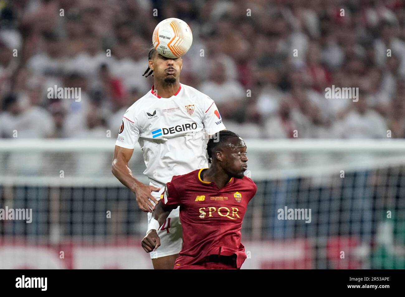 Sevilla's Loic Bade, top, heads the ball past Roma's Tammy Abraham