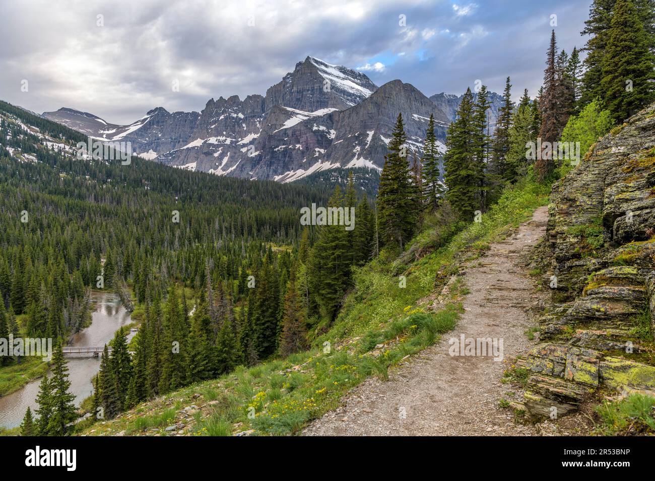 Grinnell Glacier Trail - A stormy Spring evening view of cliff-side Grinnell Glacier Trail, Many Glacier, Glacier National Park, Montana, USA. Stock Photo