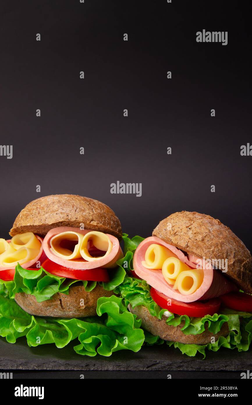 French style ham and cheese sandwiches on dark grey background with