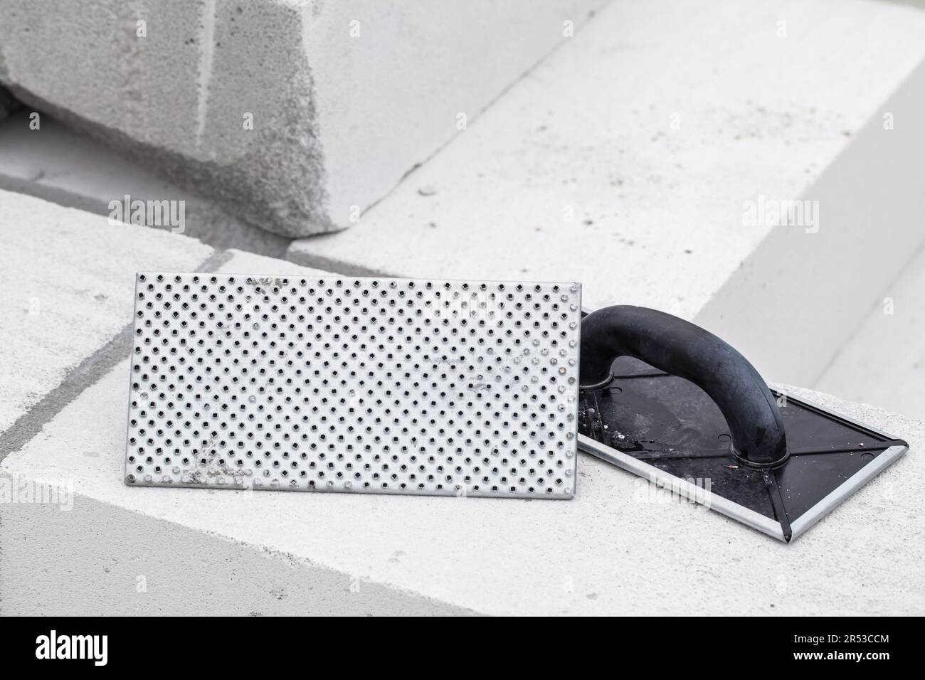 Scraper, bar trowel for polystyrene. Tool for wall materials. Abrasive