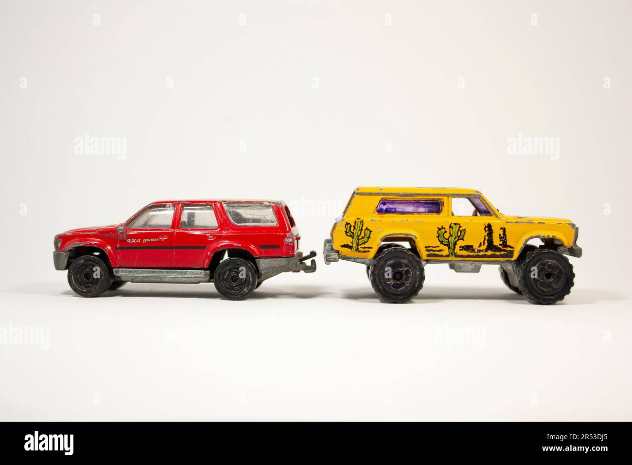 two Sport Utility Vehicle toy car red and yellow color on white background Stock Photo Alamy