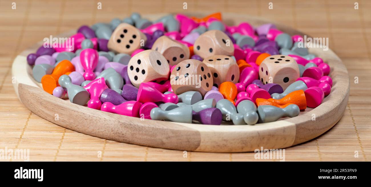 Many colorful game pieces and dice for board games Stock Photo