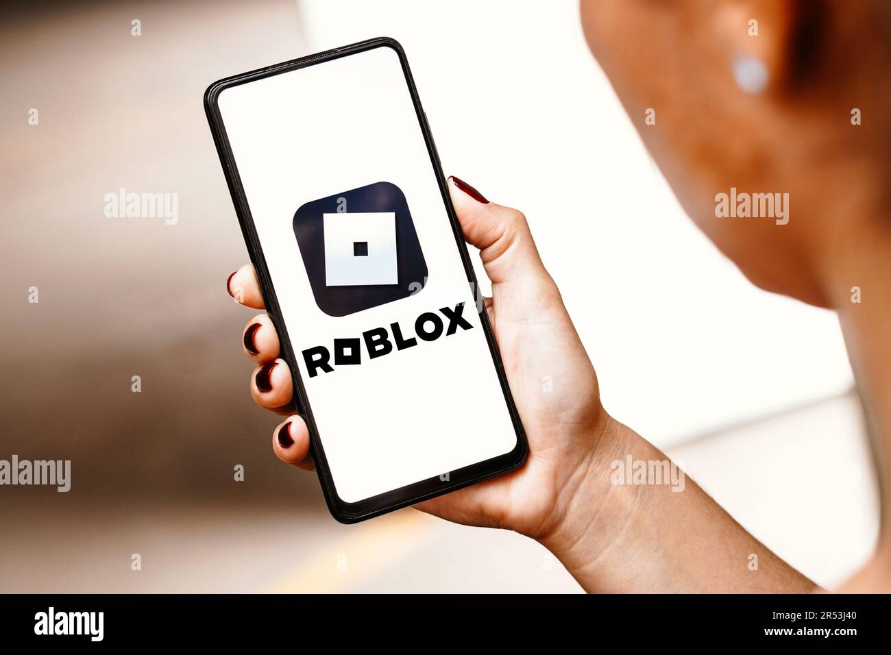 Person holding smartphone with website of US video games company Roblox  Corporation on screen in front of logo. Focus on center of phone display  Stock Photo - Alamy