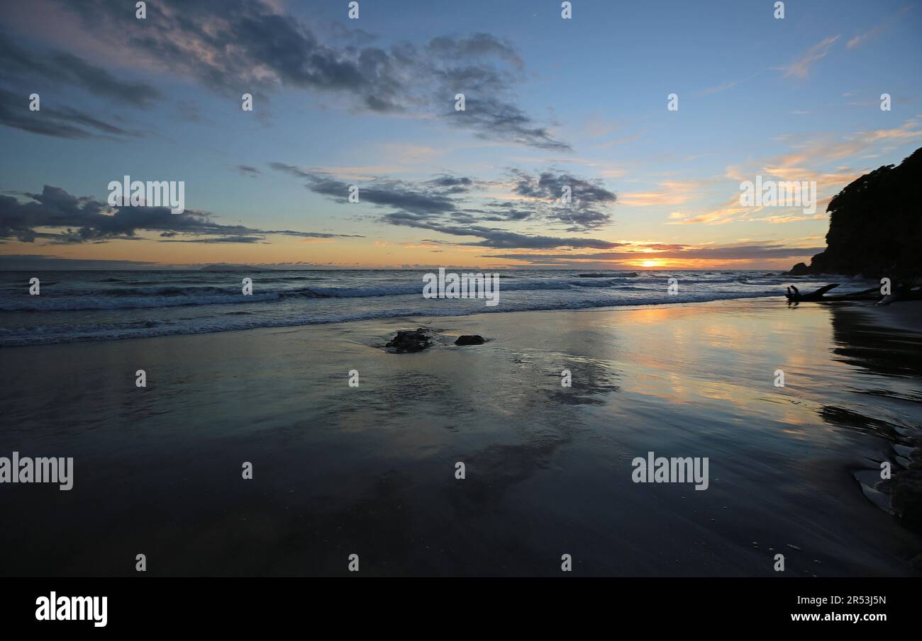 Sunrise reflection - Waihi Beach - New Zealand Stock Photo
