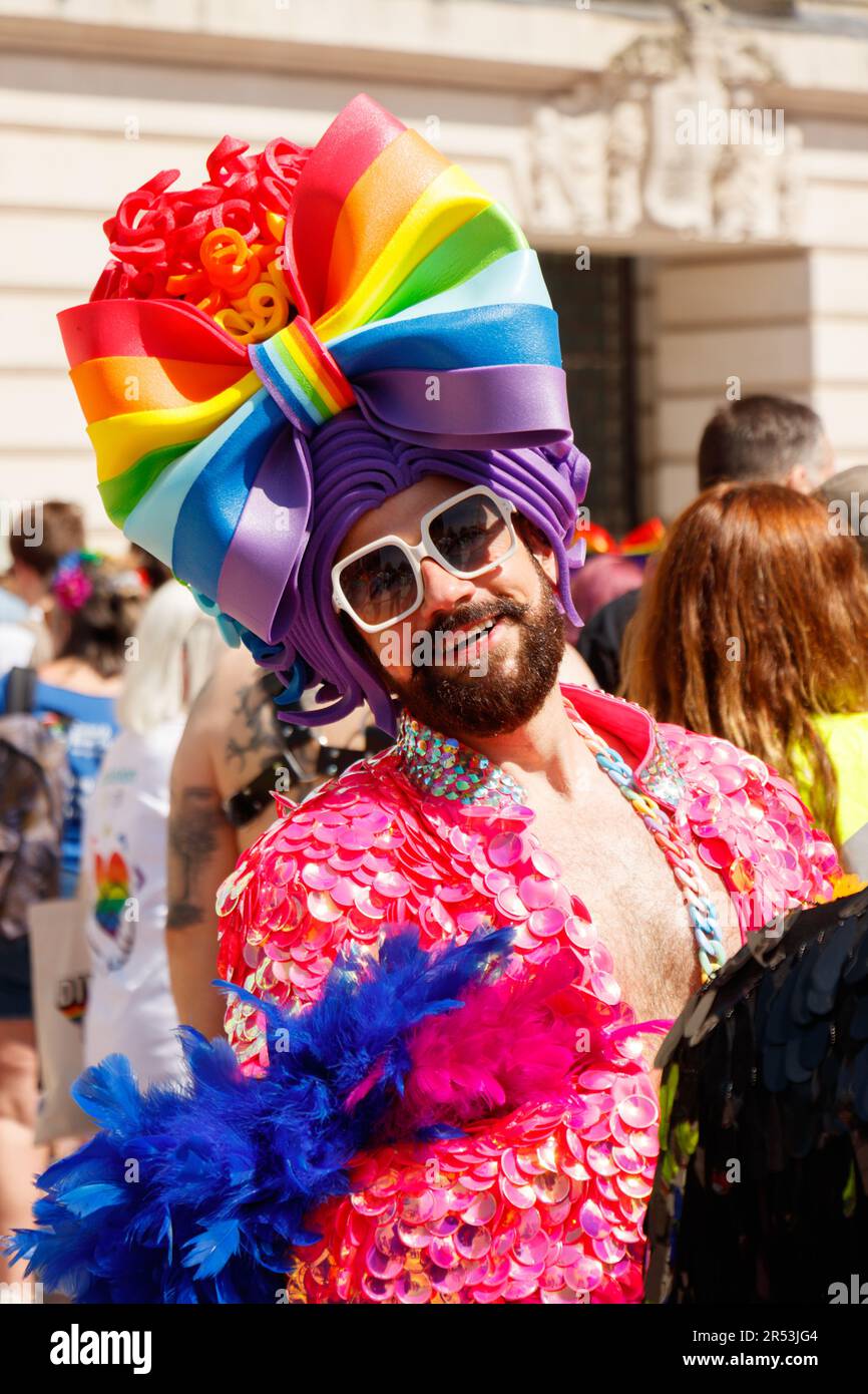 bearded man in rainbow hat and fancy dress at Birmingham LGBTQ gay Pride Saturday May 27th 2023 Stock Photo