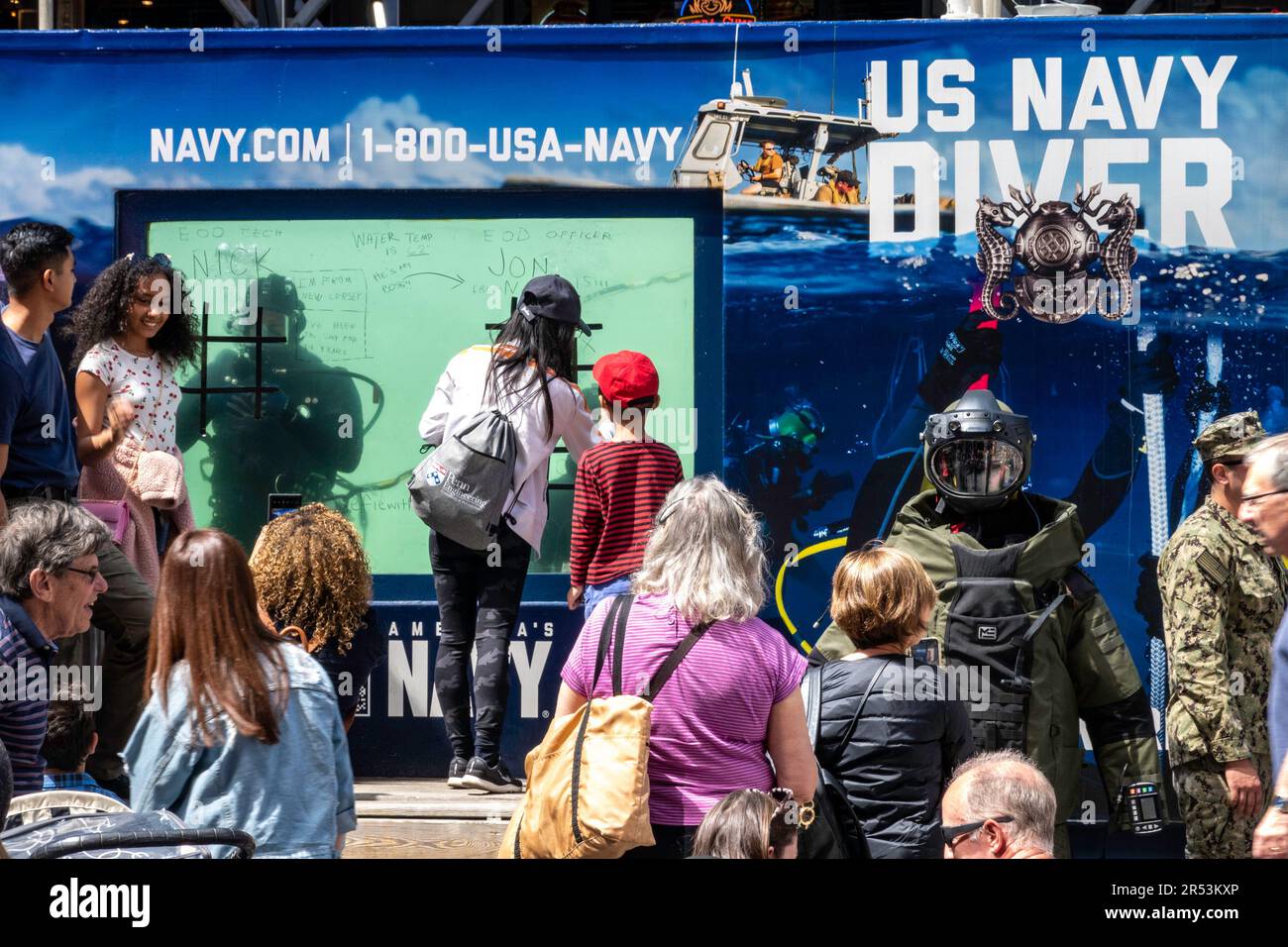 Crowds gather for fleet week in Times Square at the US Navy underwater diver tank, 2023, New York City, United States Stock Photo