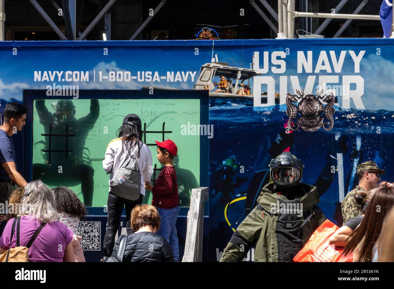 Crowds gather for fleet week in Times Square at the US Navy underwater diver tank, 2023, New York City, United States Stock Photo