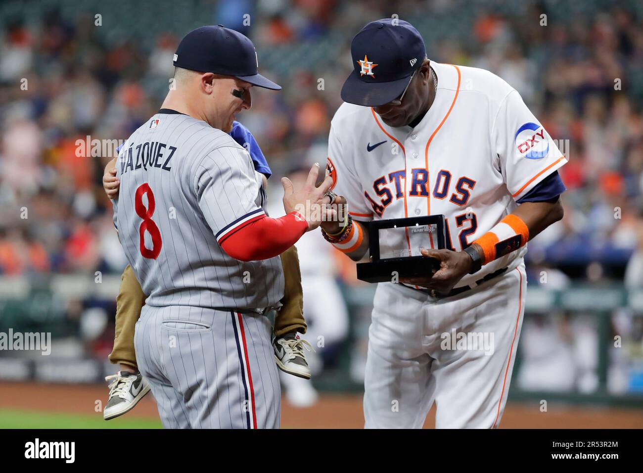 Minnesota Twins' Christian Vazquez, left, holds his son as Astros