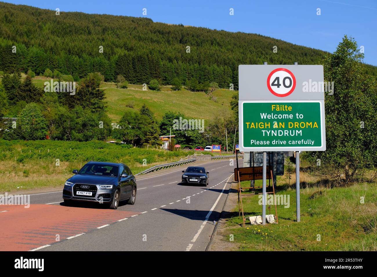 Clear blue skies and bright sunshine at Tyndrum, cars on the A82 road Tyndrum, Scotland Stock Photo