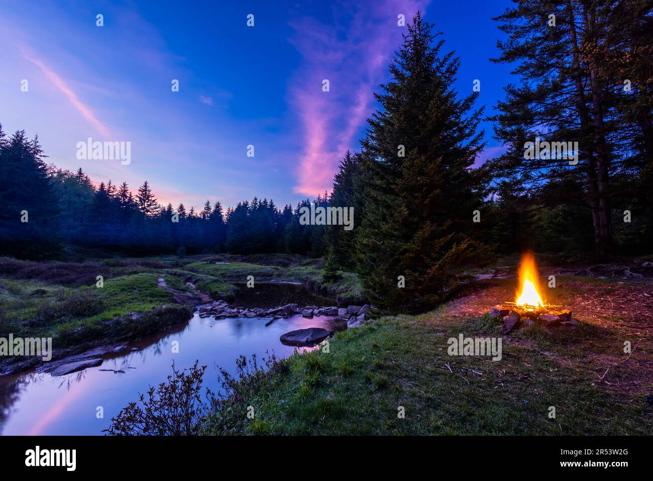 In the Dolly Sods Wilderness in West Virginia, a campfire burns next to the Left Fork of Red Creek where the Blackbird Knob Trail crosses it. Stock Photo
