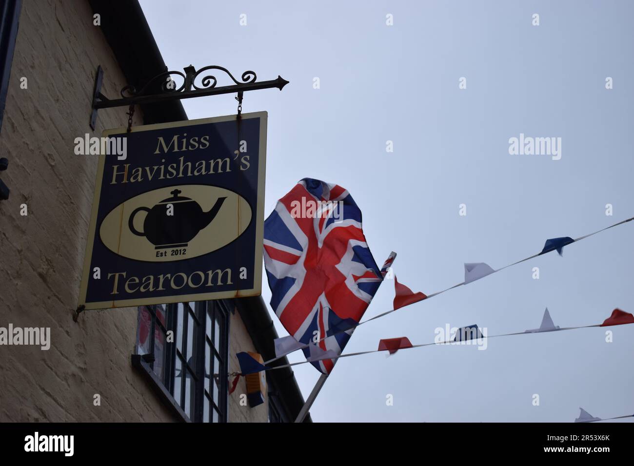 Sign for Miss Havisham's Tea Room in Stony Stratford, with Union Jack and bunting. Stock Photo
