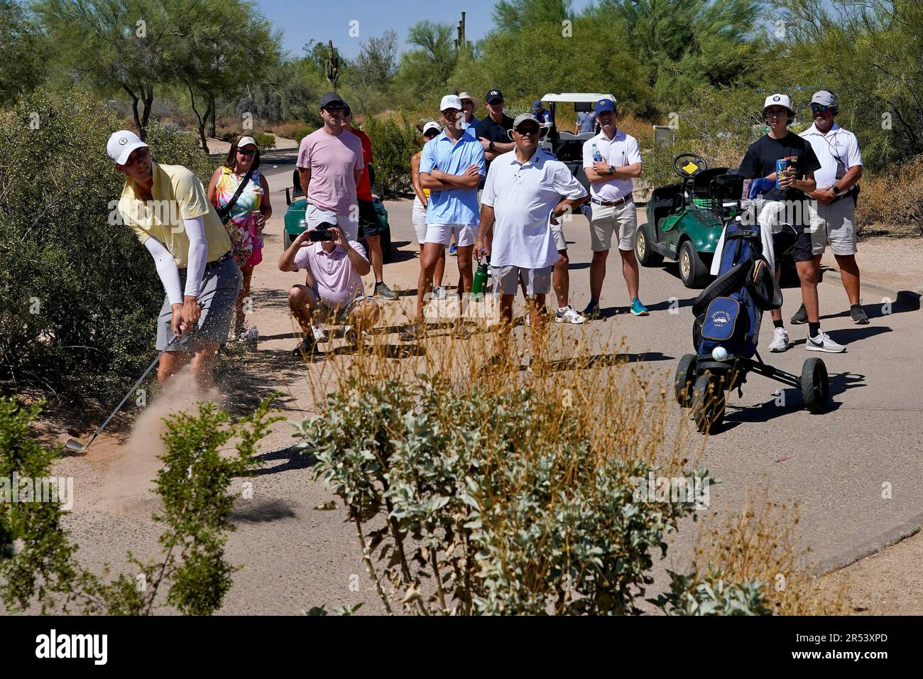Tech golfer Ross Steelman hits from the cart path along the