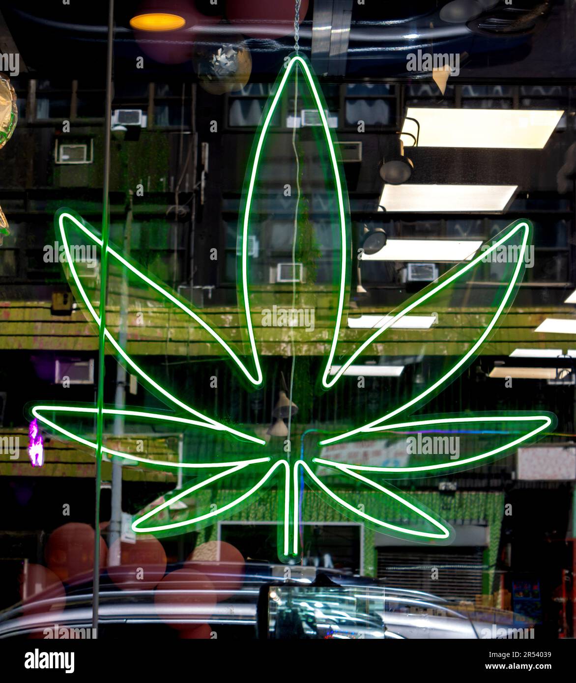 neon green sign of a marijuana leaf in the window of a legal pot dispensary Stock Photo Alamy