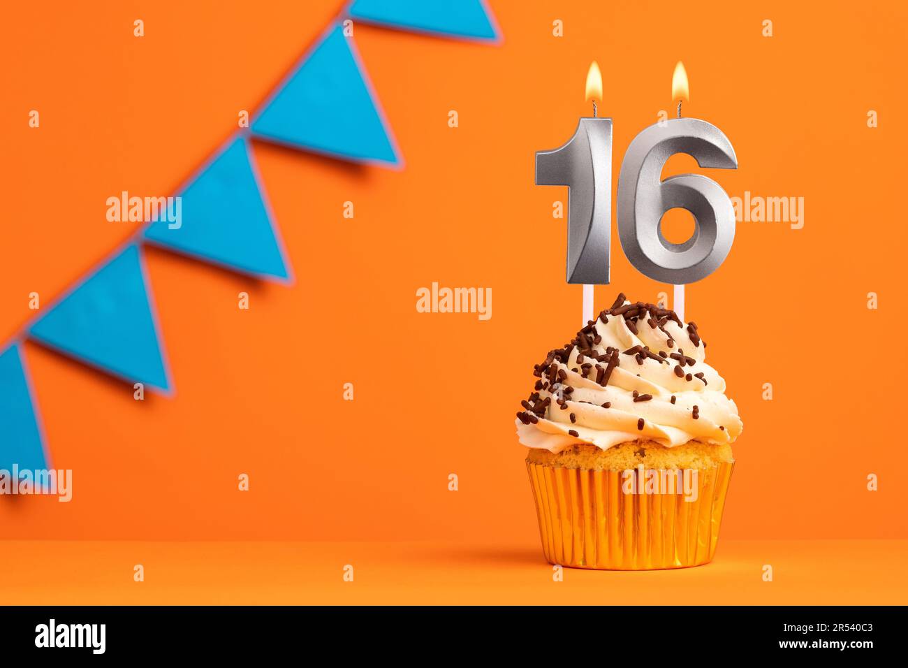 Birthday cake with candle number 16 - Orange background Stock Photo