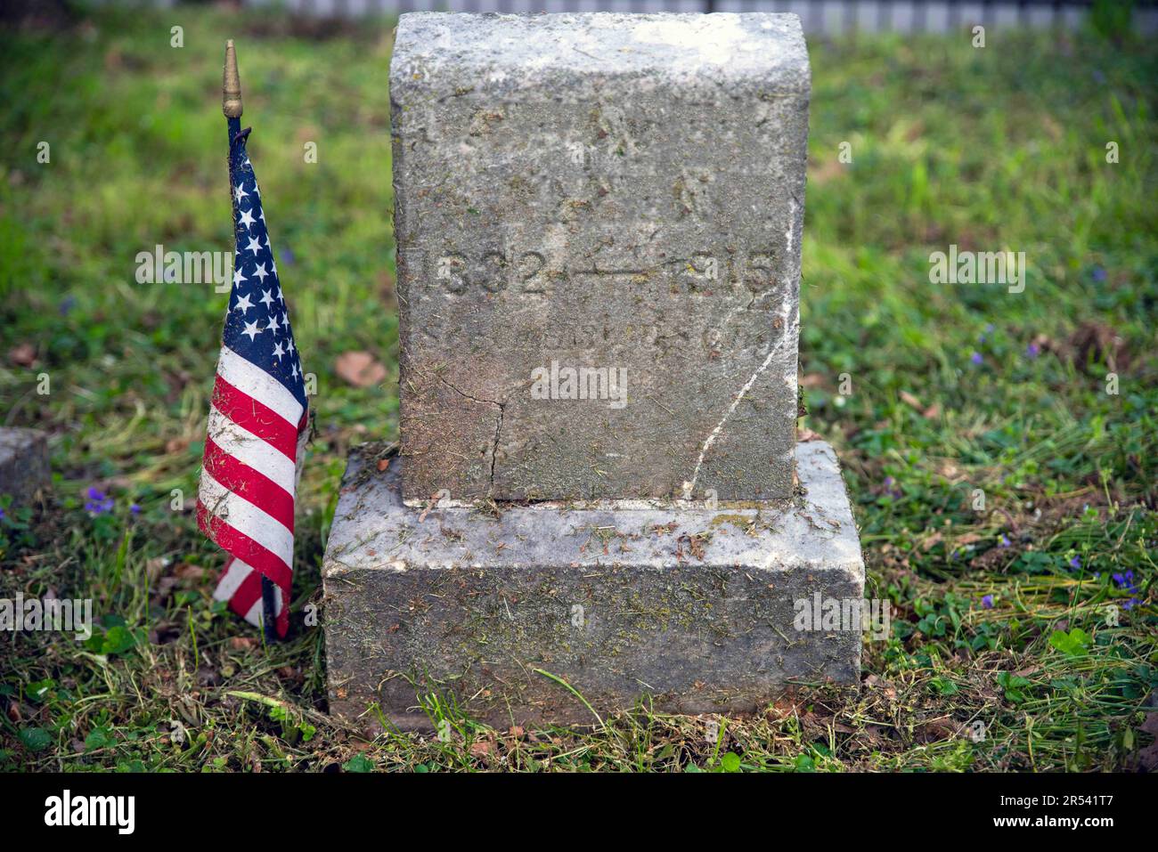 Civil War soldier cemetery grave stone with American Flag Stock Photo