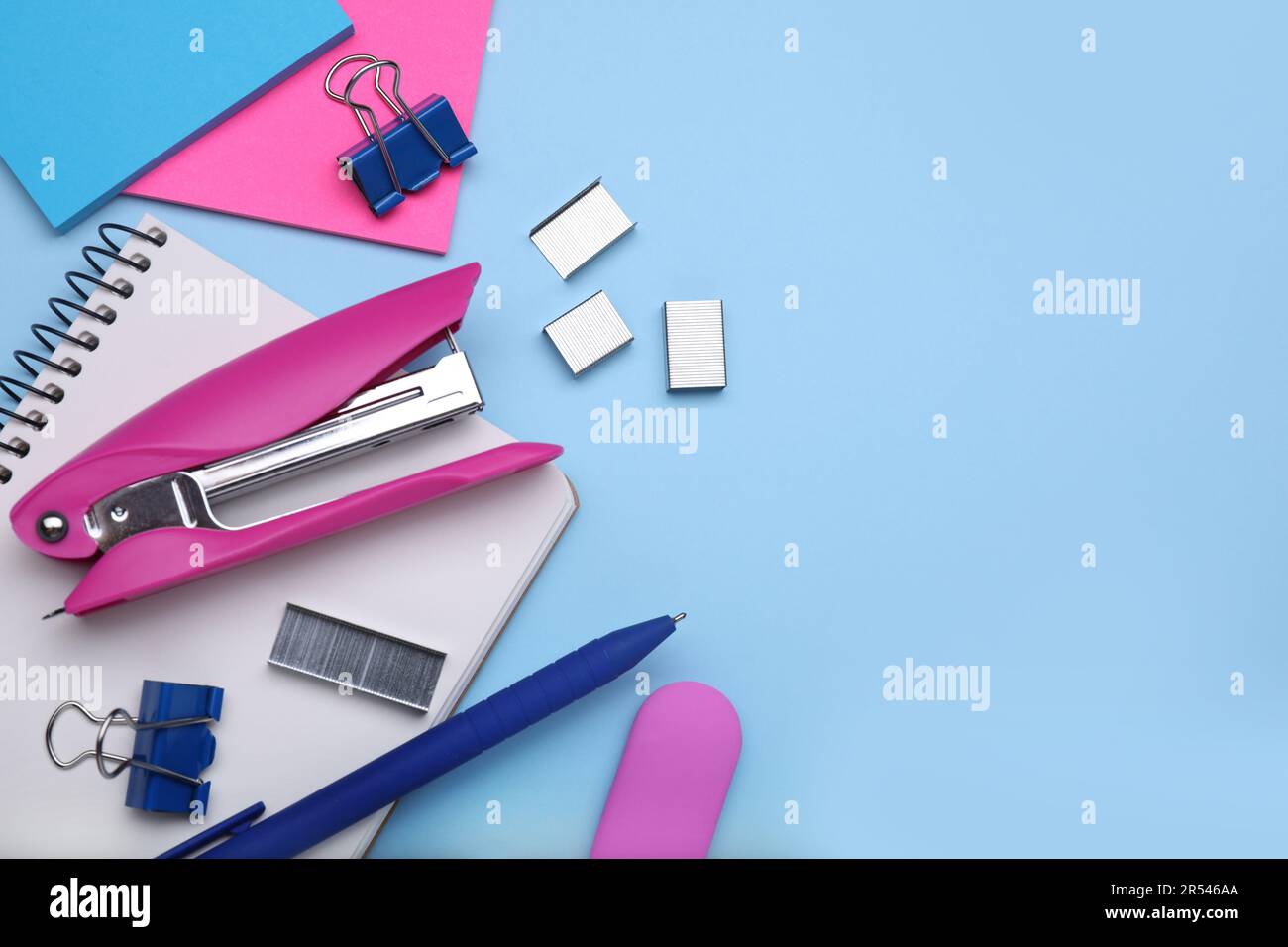 Flat lay composition with new stapler on light blue background, space ...