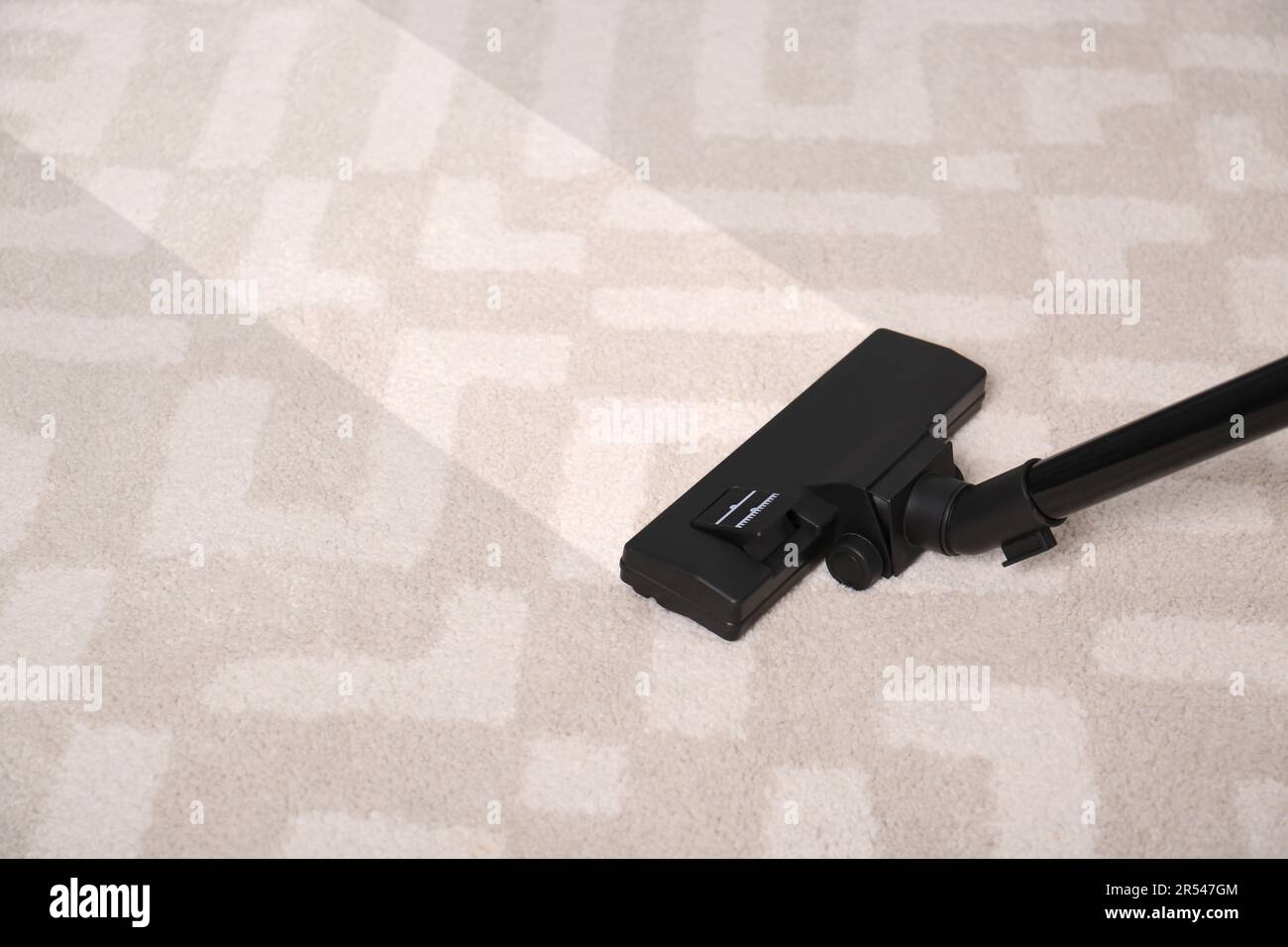 Vacuuming carpet. Clean area after using device, closeup Stock Photo