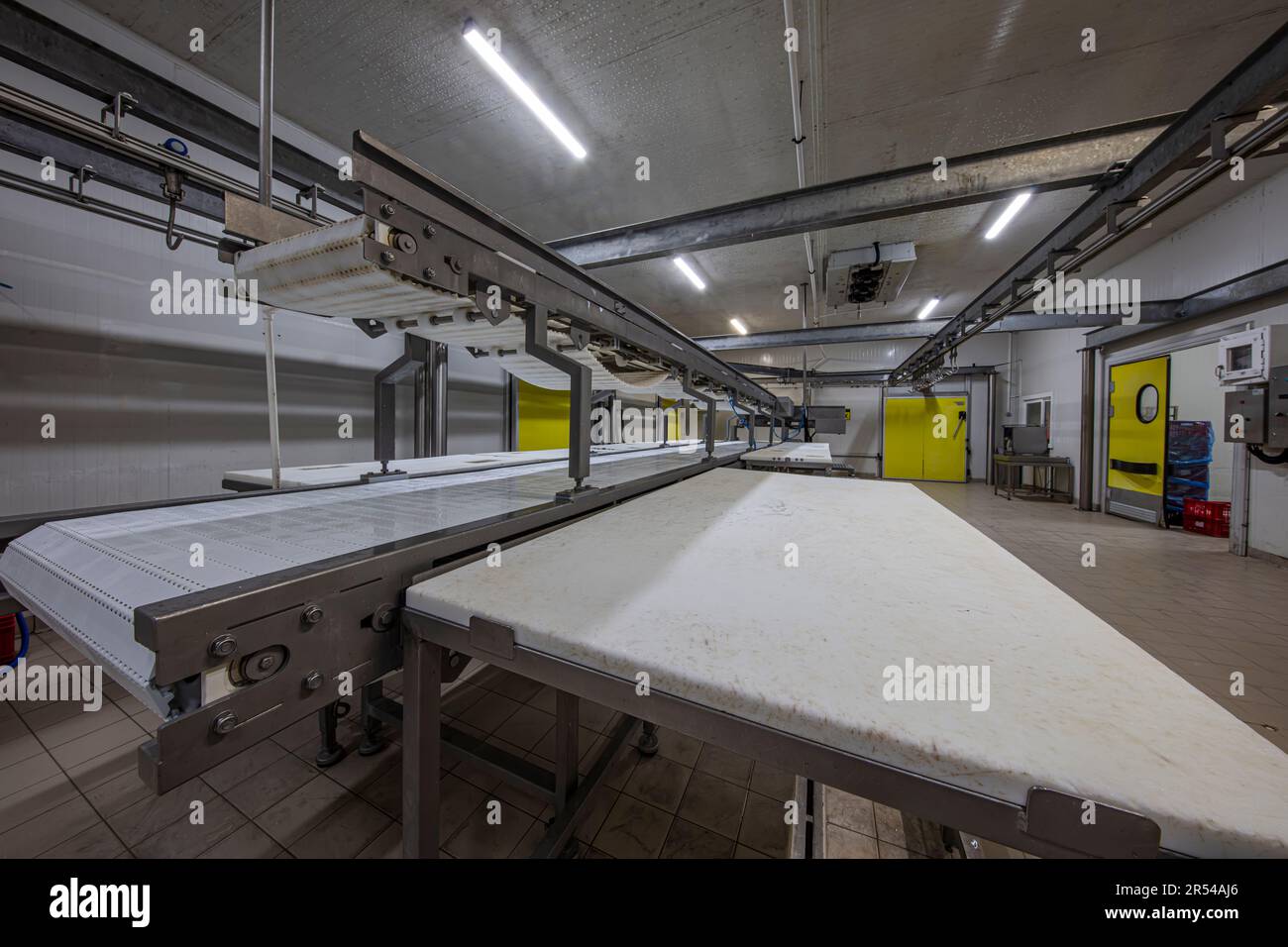 Meat processing machines at meat factory. Cutting meat in